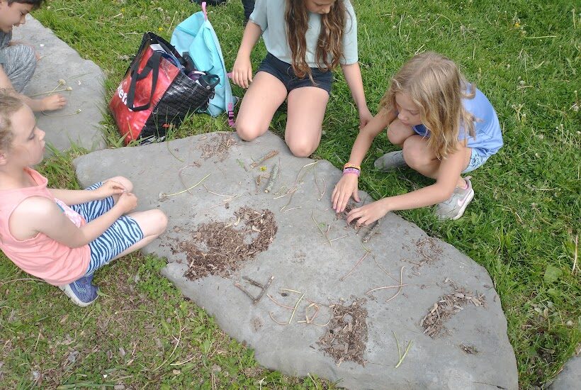 Students creating art using objects found in nature.